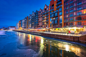 The granaries island over Motlawa river at snowy dusk, Gdansk. Poland