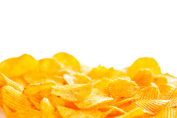 A foreground of grooved fried potato chips that fades into a smooth blur