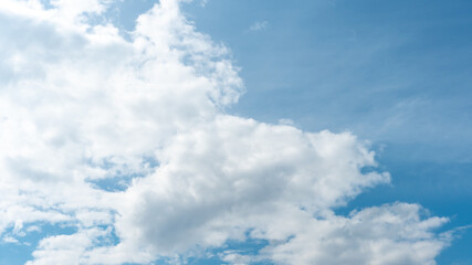 Beautiful fluffy clouds in the evening sky. The sunlight gives a side light on the clouds. Clouds before rain.