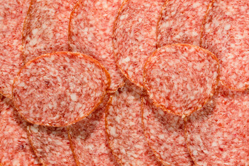 Slices of ham sausage as a natural background . Tasty salami slices ias a natural background . Smoked Sausage slices, as a natural background