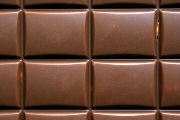 close-up of  milk chocolate bar with hazelnuts
