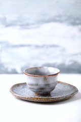 Traditional, handcrafted ceramic on bright wooden background. Copy space.	