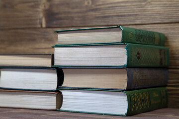 Stack of books on wooden table