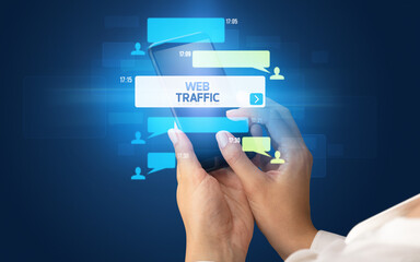 Female hand typing on smartphone with WEB TRAFFIC inscription, social networking concept
