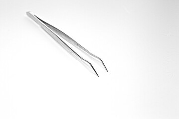 Isolated medical tweezers on white background for medical examination of sick patients surgery by doctor at hospital and clinic dental hygiene at dentist disposable accessory medical tool copyspace