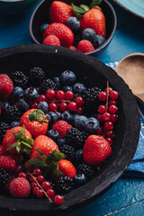 Healthy breakfast eating a mix of fresh berries fruits