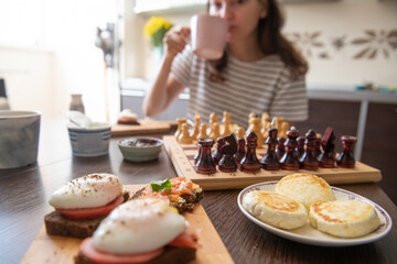 Healthy breakfast and chess game in the morning at home (Selective focus)