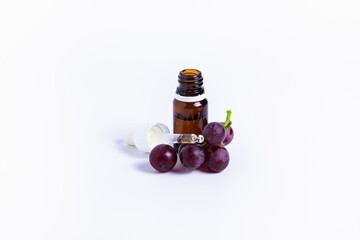 isolate bunch of grapes with a bottle of oil on a white background