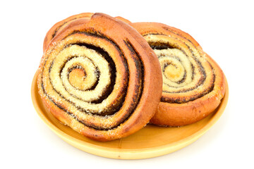 Buns with poppy seeds on a wooden plate isolated on a white background.