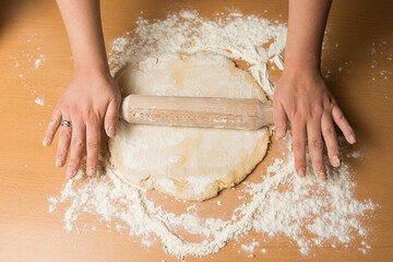 Female hands making dough for baking or bread.
