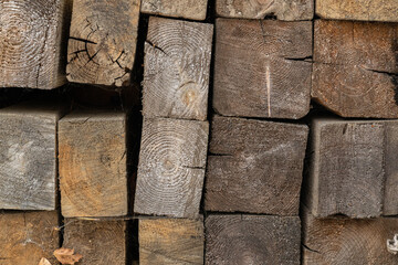 firewood stacked in a woodpile. Aged timber. Pattern