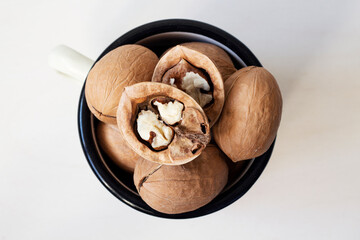 Walnuts in a mug on a white background. Close up