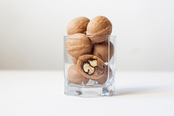 Walnuts in a glass on a white background