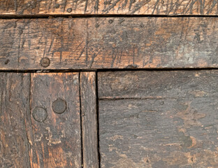 weathered natural wooden structure closeup, brown background