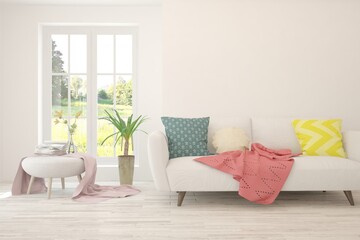 White living room with sofa and summer landscape in window. Scandinavian interior design. 3D illustration