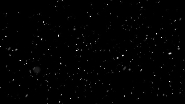 Light soft  snow falling isolated on black 4k seamless loop.  Place it over your footage in screen or add mode.