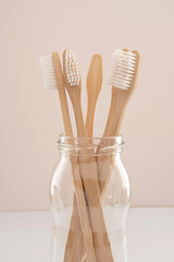 Close-up of bamboo toothbrushes in a glass