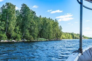 Russia, Lake Ladoga, August 2020. View of the lake shore from the board of a pleasure boat.