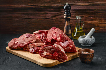 Assortment of raw lamb meat on wooden tray