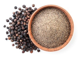Ground black pepper in a wooden bowl and peppercorns on a white background, isolated. Top view - 412969353