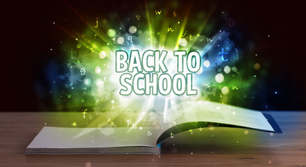BACK TO SCHOOL inscription coming out from an open book, educational concept