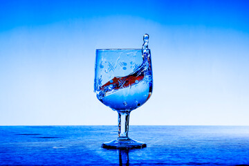 Splashes of fresh clear water in an exquisite crystal glass