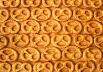 abstract background of pretzels on wooden surface