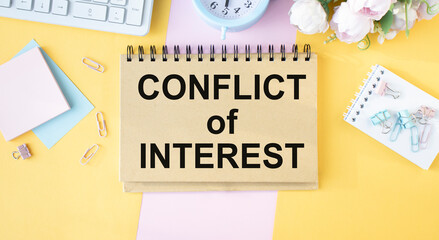 Conflict of interest memo written on a notebook