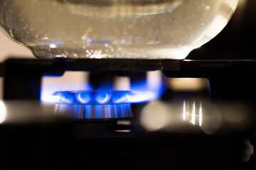 Burning Stove Close Up Shot. Boiling Water in Glass Teapot. Kitchen Utensil Detail Shot. 