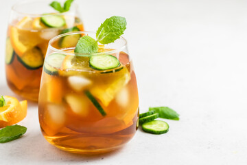 Cold brew cucumber orange iced tea in glasses. Space for text.