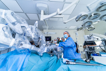 Doctors use robotic equipment in modern operating room. Medics provide neurosurgery operation. Futuristic medicine.