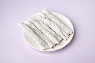 Til pitha a traditional food of Assam  isolated stock image.