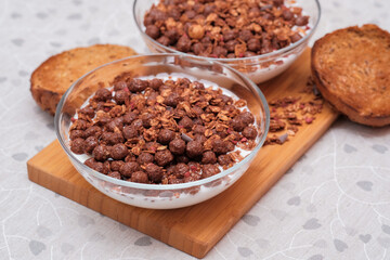 Healthy breakfast with natural yogurt, cereal and granola in glass bowls
