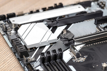Macro shot of a silver heat sink dissipating heat from the chipset on the motherboard of a desktop computer.