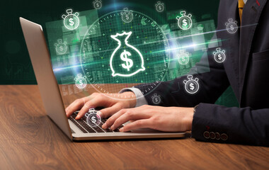 business hand working in stock market with dollar bag icons coming out from laptop screen