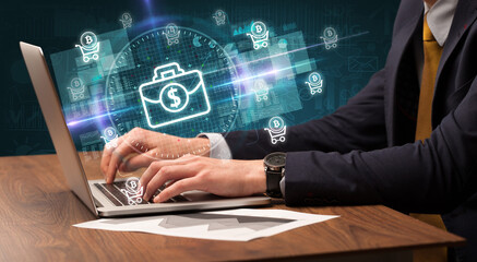 business hand working in stock market with briefcase icons coming out from laptop screen