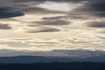 clouds in the sky, evening landscape with hills