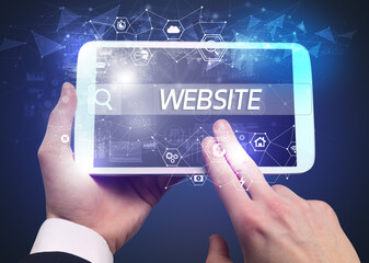 Close-up of a tablet searching WEBSITE inscription, hi-tech computing concept