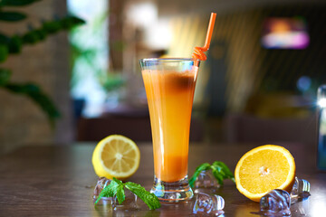 orange cocktail with ice and slices on the table