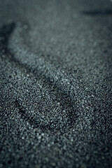 Surface of fine black sand with a pattern