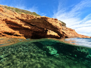 Fototapeta na wymiar Split underwater photo of tropical exotic Caribbean emerald calm sea rocky bay