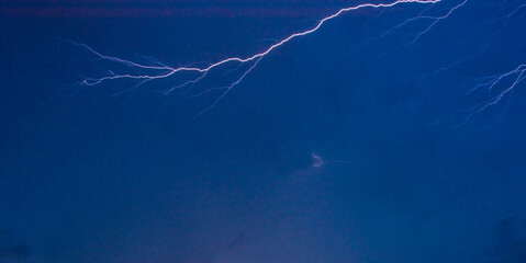 Storm, beautiful rays cutting through the skies and brightening the night.