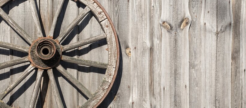wooden background old wooden wheel on the wooden wall. Village,  ranch