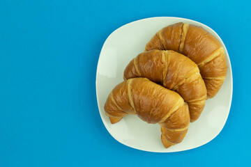 Croissants on a white plate with space for text