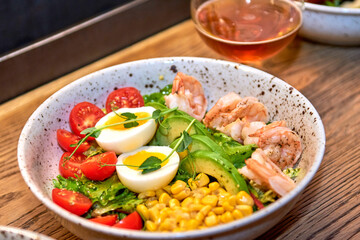 Delicious shrimp in restaurant on a wooden table, no people are visible. Tasty seafood with beer in cafe or pub menu.