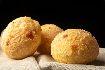 Cheese bread from Brazil, Arrangement with cheese bread on fabric with black background, selective focus.