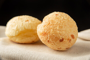 Cheese bread from Brazil, Arrangement with cheese bread on fabric with black background, selective focus.