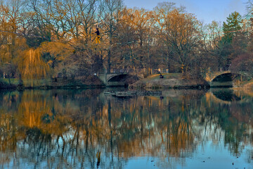 Sportsman walking tightrope on a lake surrounded by yellow trees (3)