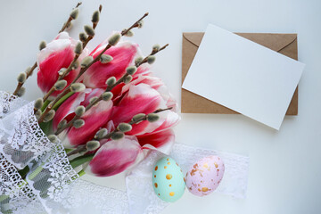 Easter greeting card mockup. spring flowers, willow twigs and Easter eggs. space for text 