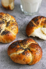 Sweet buns with poppy seeds served with milk.